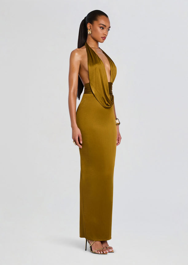 Side view of the olive gold Payton Dress on a model, halter neckline and sleek satin column silhouette.