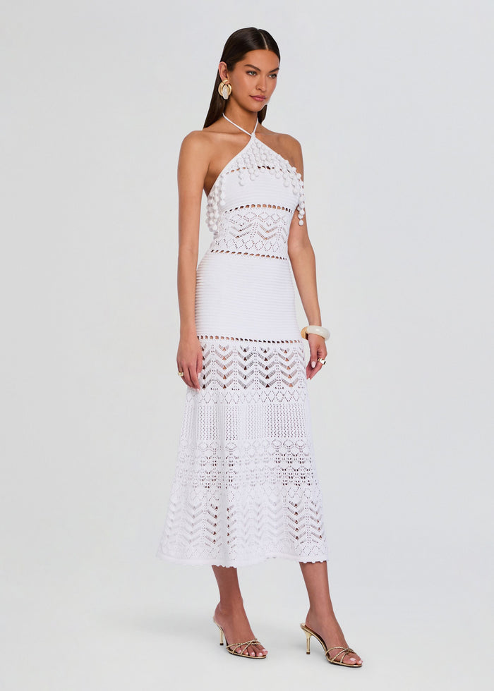 Full-length view of a model wearing the white Perette Crochet Dress with halter neck and crochet skirt media 3 of 5
