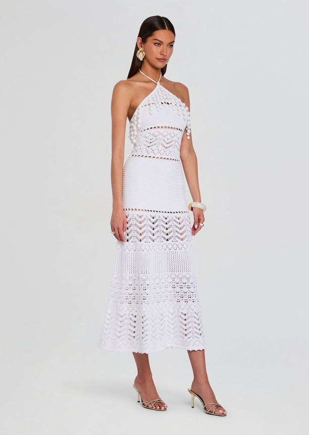 Full-length view of a model wearing the white Perette Crochet Dress with halter neck and crochet skirt