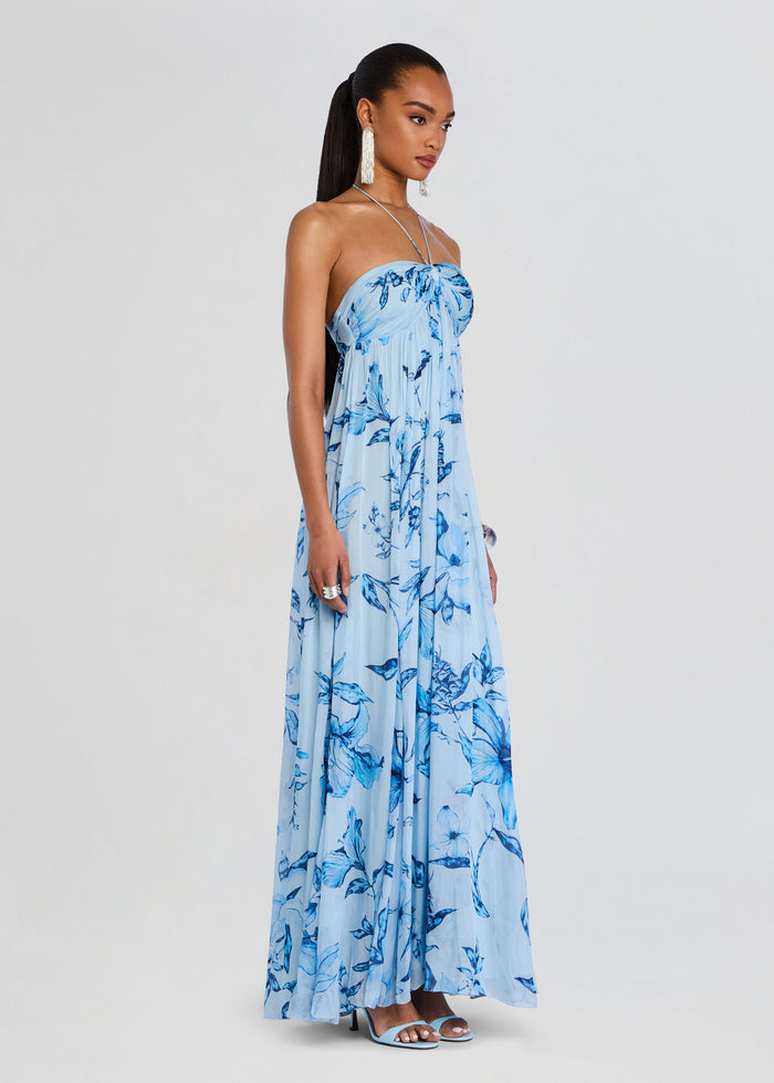 Full-length shot of a model wearing the Milo Strapless Flared Dress in a light blue floral print media 3 of 5