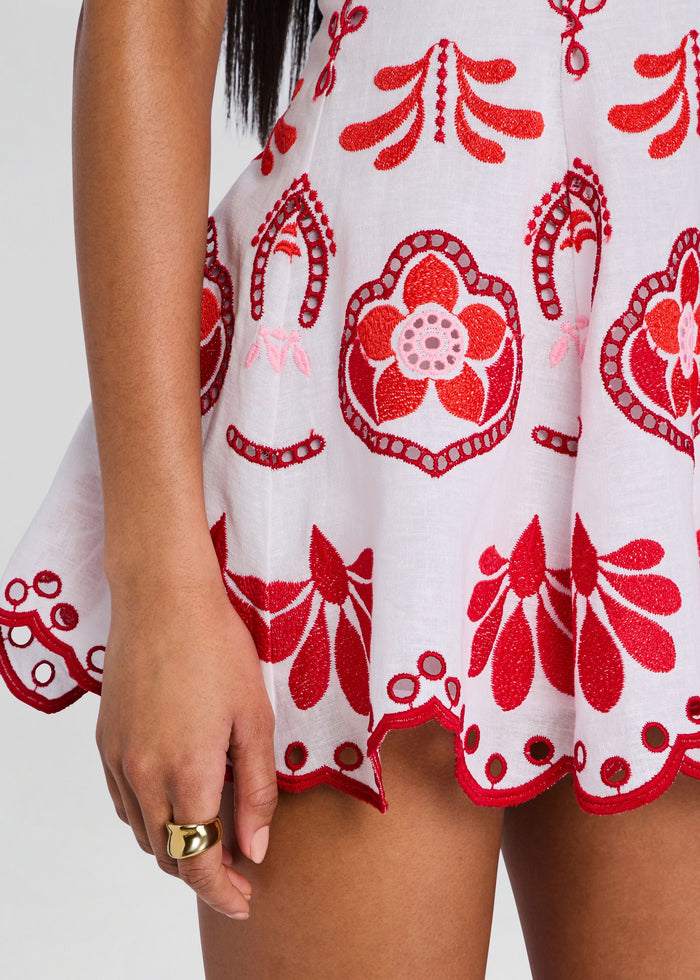 Close-up of red floral embroidery on white fabric from the Jela Short Dress media 2 of 5