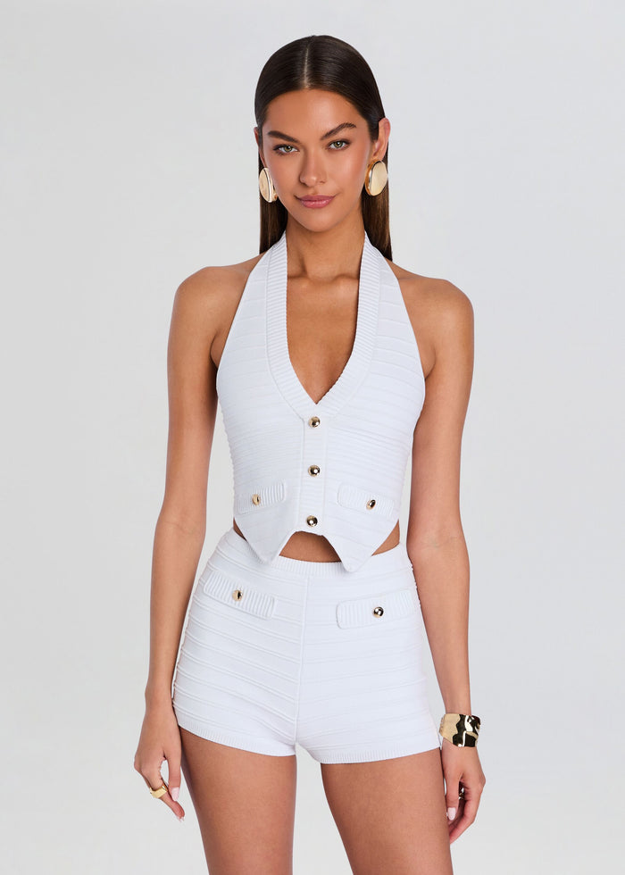 Model wearing white halter neck Tinsley Bandage Knit Vest with ribbed texture and front buttons media 1 of 5