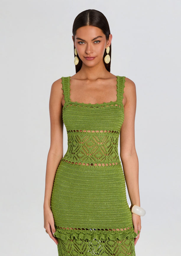 Front view of the green crochet Winona dress with wide straps and intricate lace panels at the waist and hem.