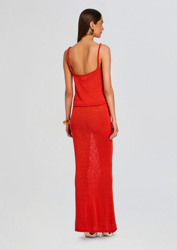 Back view of a model wearing a red knit tank top with a matching long skirt and braided straps.