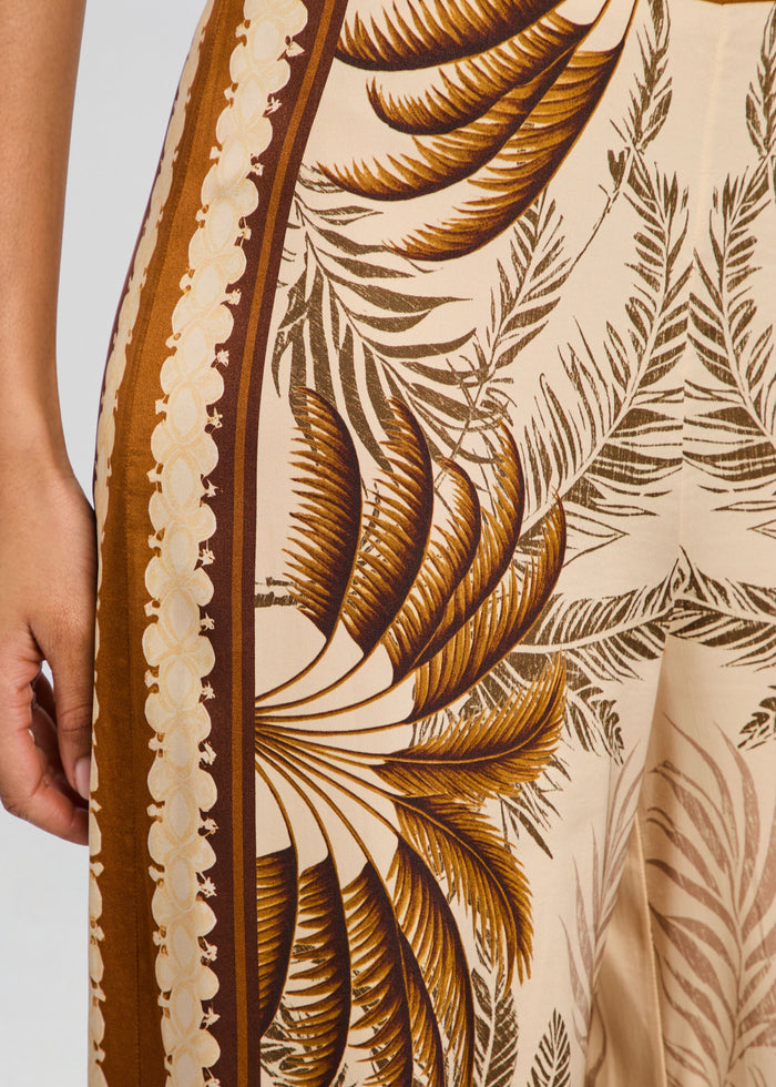 Close-up of the tropical palm print on Sunny Pant fabric with brown border on cream background. media 3 of 5