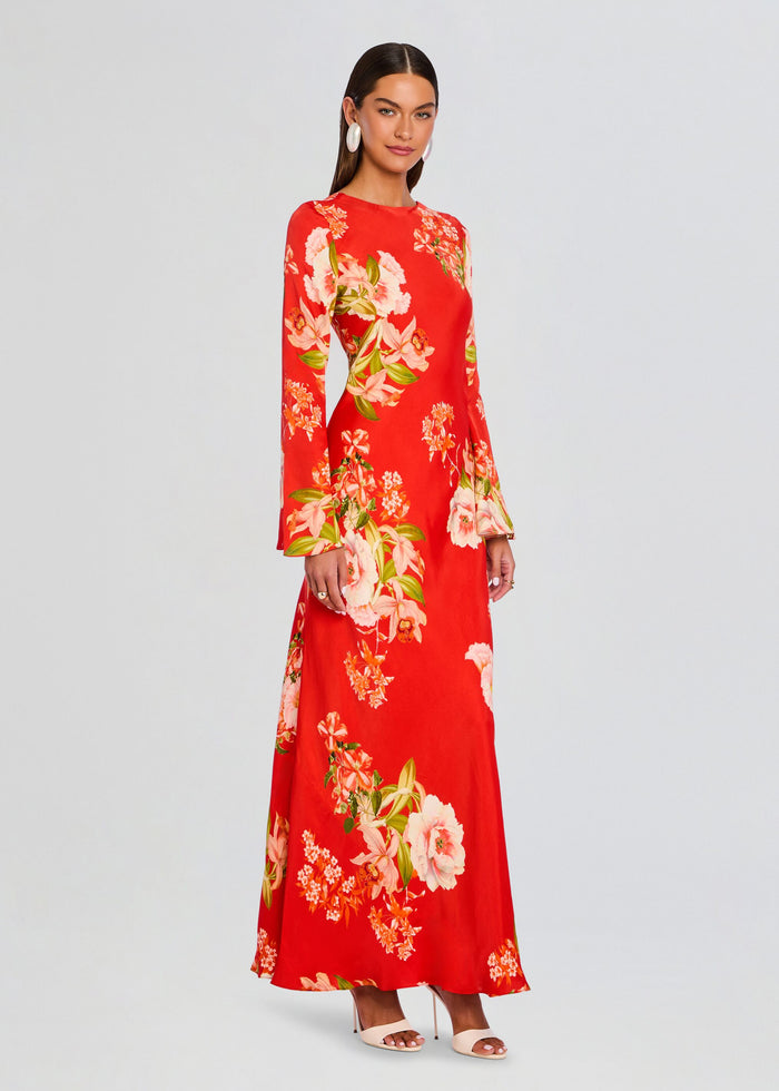 Full-body portrait of a model in a red floral maxi dress with bell sleeves and nude heeled sandals. media 4 of 5