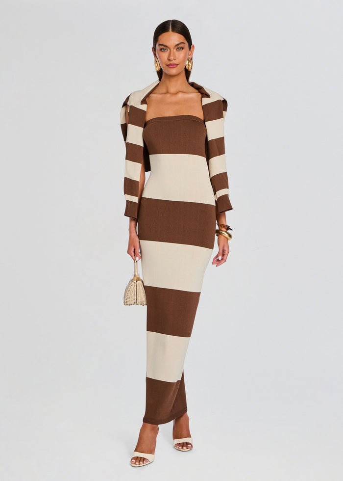 Model wearing Carrie Knit Maxi Dress with brown cream color blocks and a matching striped blazer holding a wicker handbag media 6 of 6