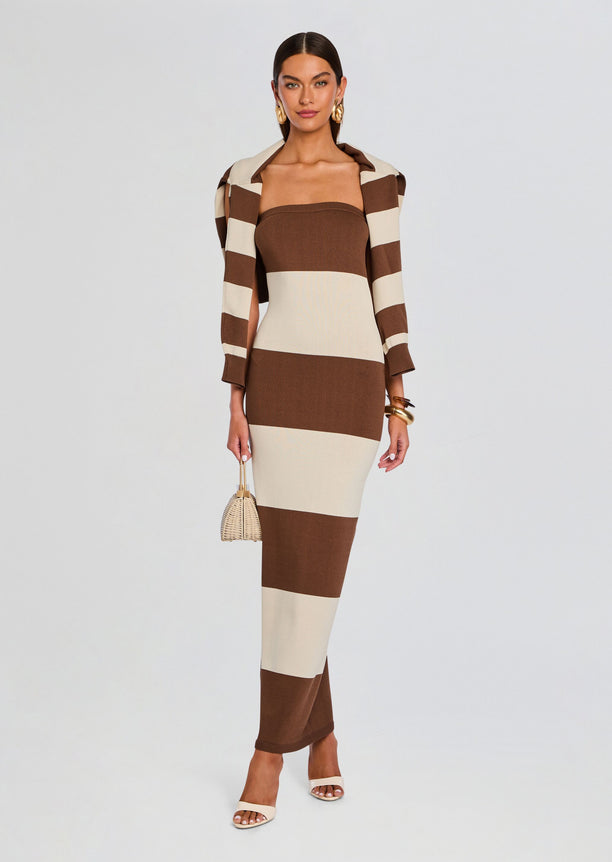 Model wearing Carrie Knit Maxi Dress with brown cream color blocks and a matching striped blazer holding a wicker handbag