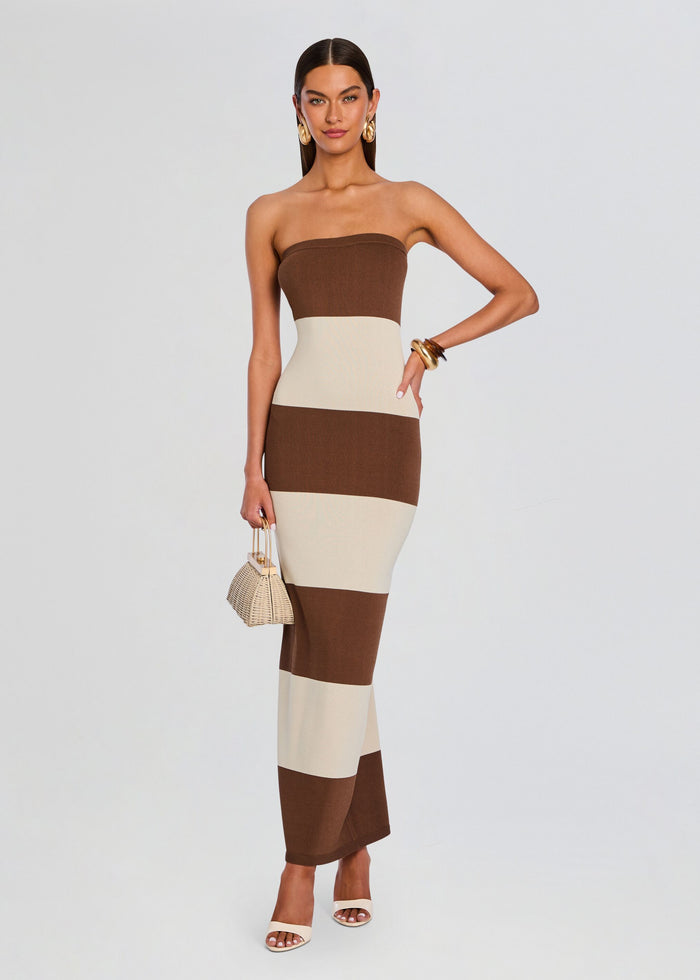 Full-length model wearing the Carrie Knit Maxi Dress in brown and cream color blocks with a small woven handbag. media 1 of 6