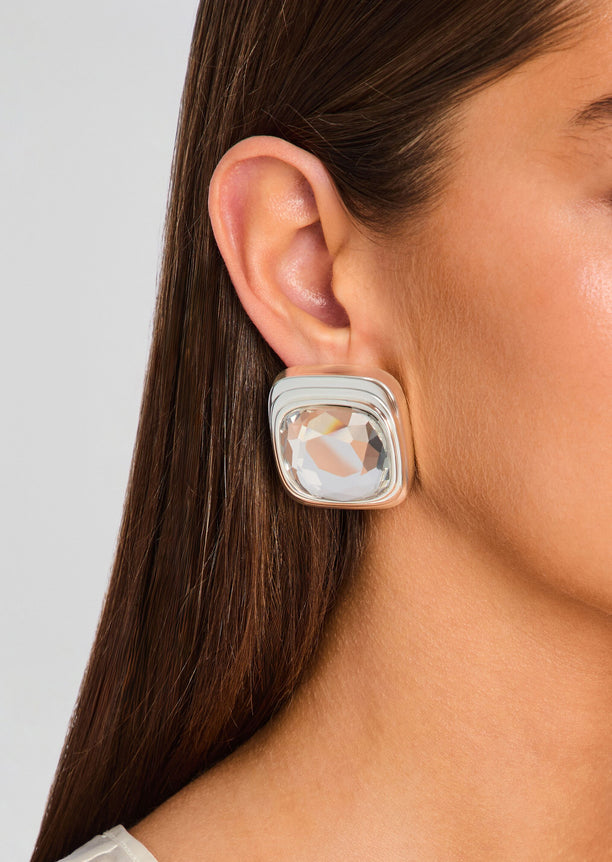 Clive earring featuring a square clear crystal set in a rounded silver bezel on the earlobe