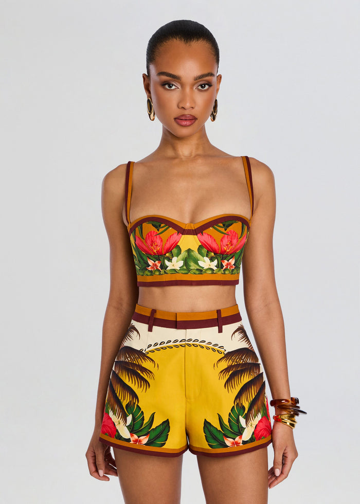 Front view of a model wearing a tropical Cricket Bustier Top with thin straps and matching printed shorts. media 1 of 5