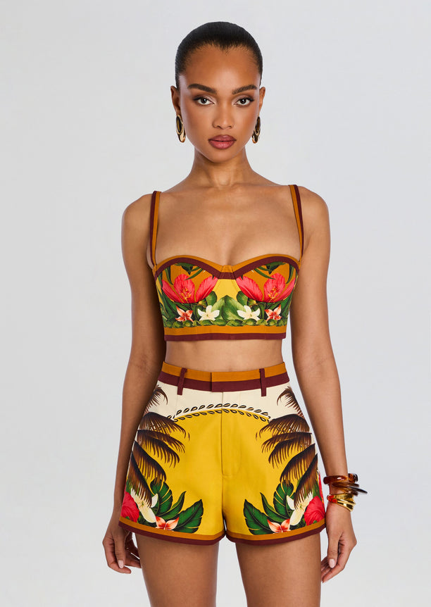 Front view of a model wearing a tropical Cricket Bustier Top with thin straps and matching printed shorts.