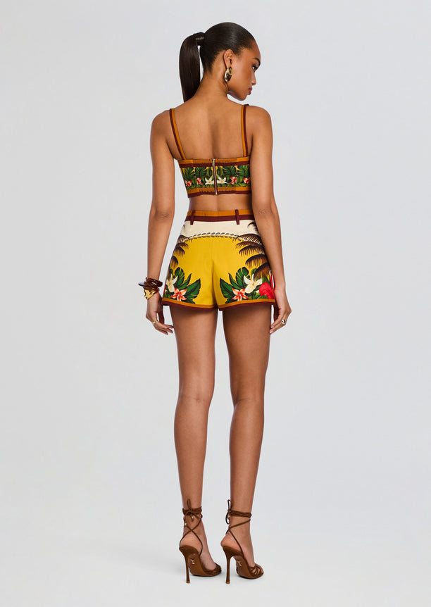 Back view of Cricket Bustier Top with tropical print and thin straps on a model showing a back zipper.