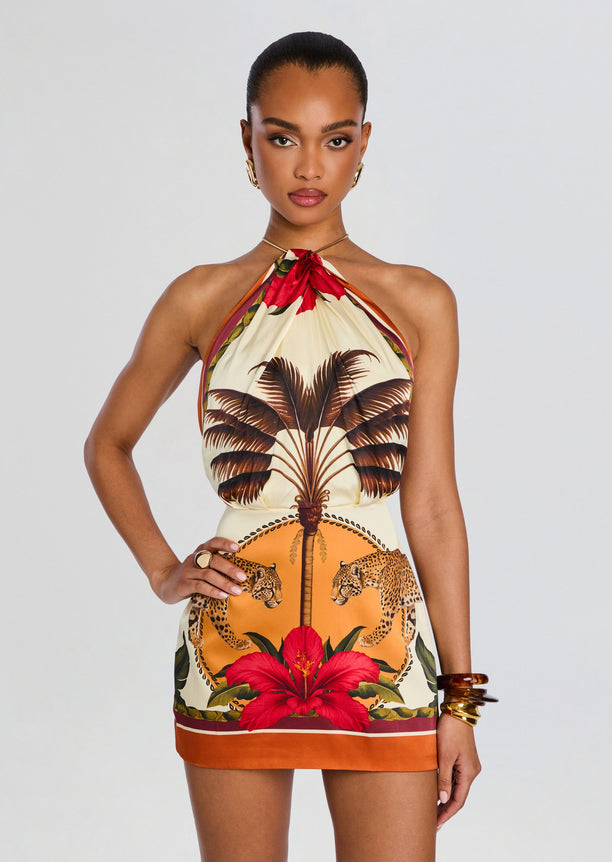 Front view of a model in a tropical print halter top and matching high waisted shorts with palm trees and leopards.