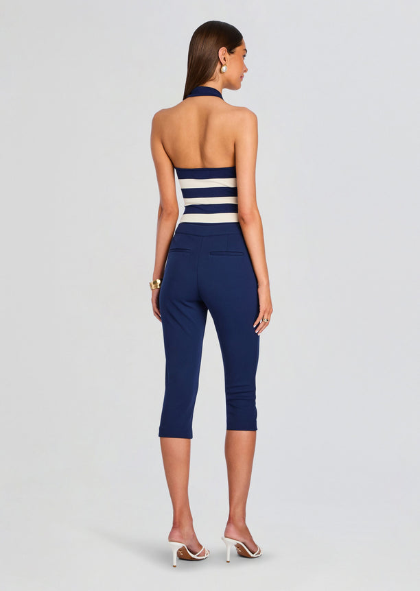 Back view of model in navy Samra Capri Pant with striped halter top