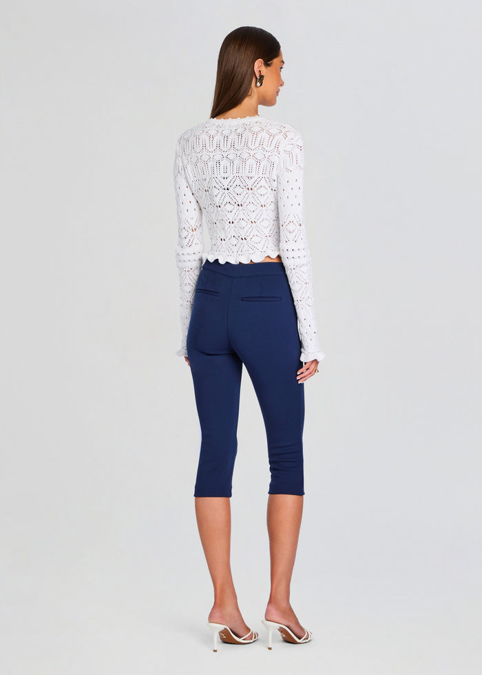 Back view of model wearing Giuliana Crochet Cardigan over navy cropped pants. media 5 of 5