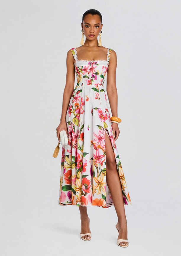 Maui Long Dress on a model in a white tropical floral print gown with lace straps and a front slit