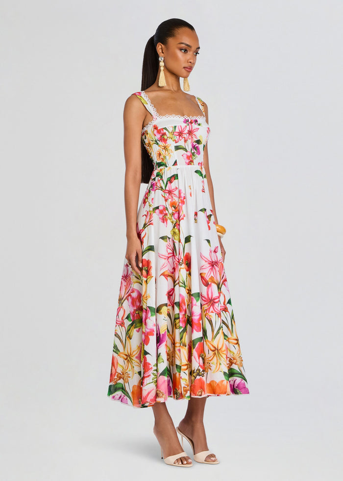 Model wearing Maui Long Dress, a white tropical floral print maxi with lace trim and wide straps. media 3 of 5