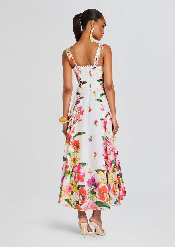 Back view of Maui Long Dress with a smocked bodice, lace trim along the top, and a floral skirt.