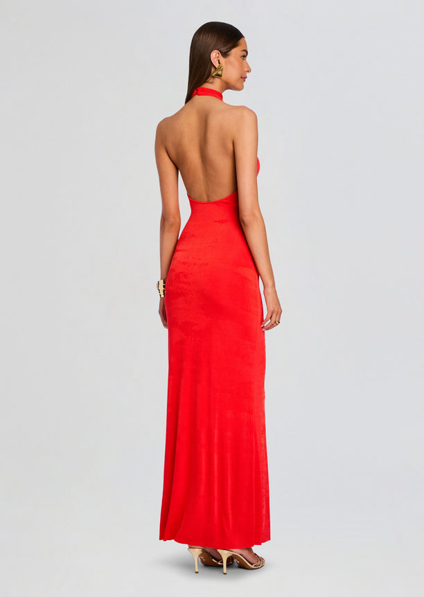 Rear view of the red halter neck maxi dress showing its open back and long skirt