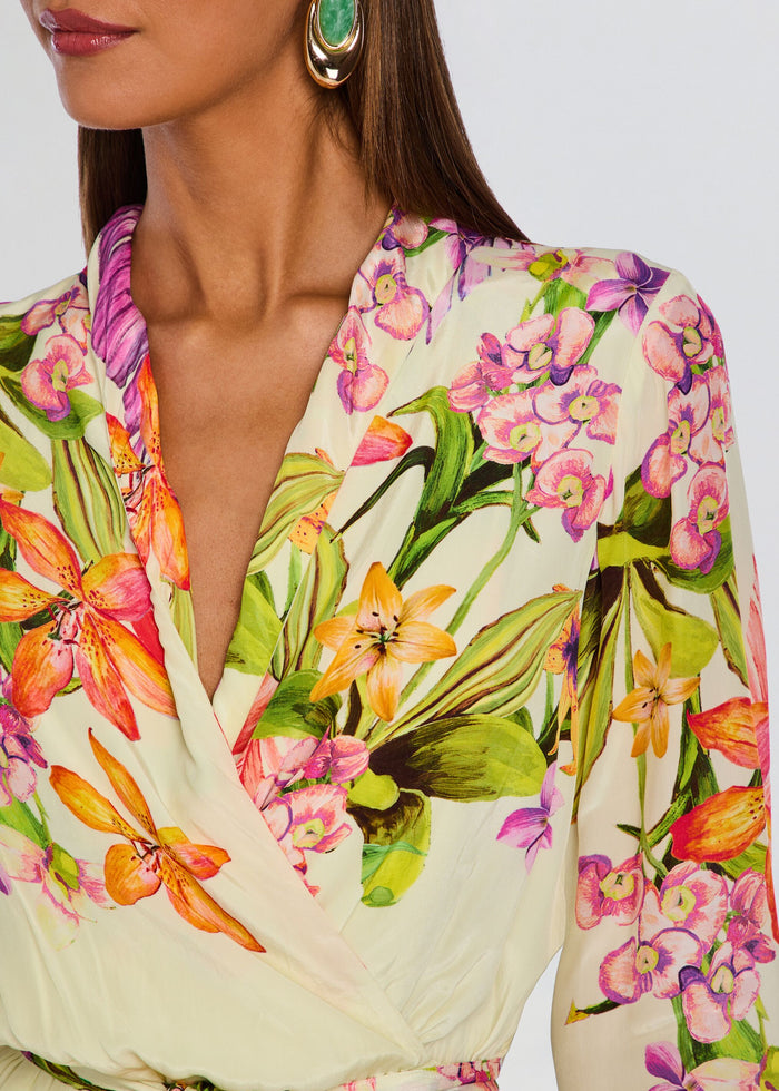 Close-up of the Dio dress fabric showing vivid tropical floral print and wrap neckline media 2 of 5
