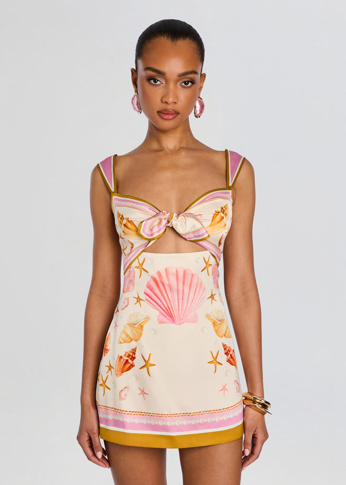 Front view of Margarie Silk Dress featuring a bow at the bust and seashell and starfish print with pink and mustard trim. media 5 of 5