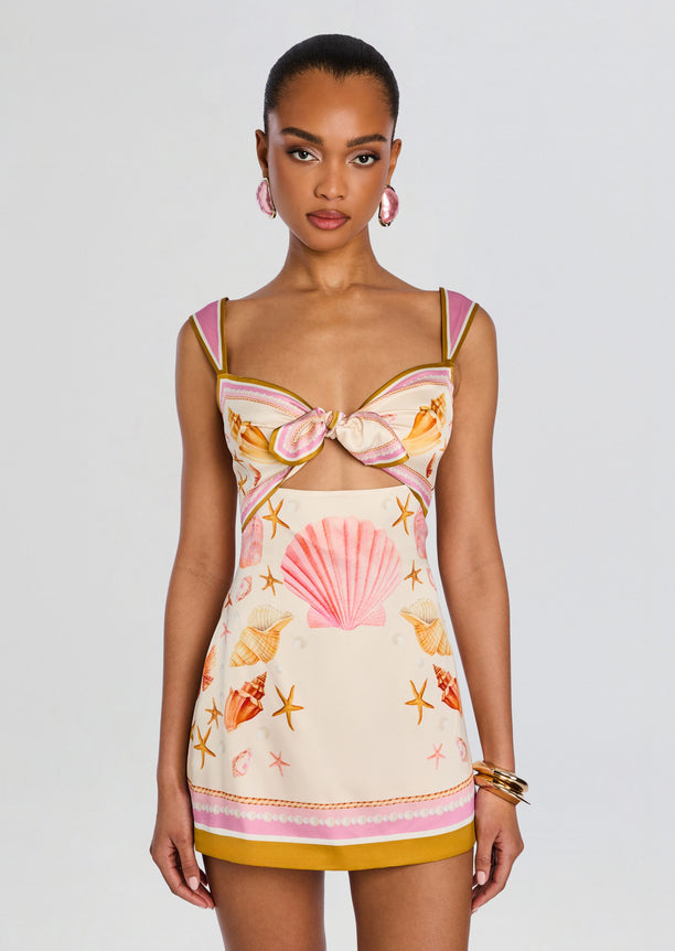 Front view of Margarie Silk Dress featuring a bow at the bust and seashell and starfish print with pink and mustard trim.
