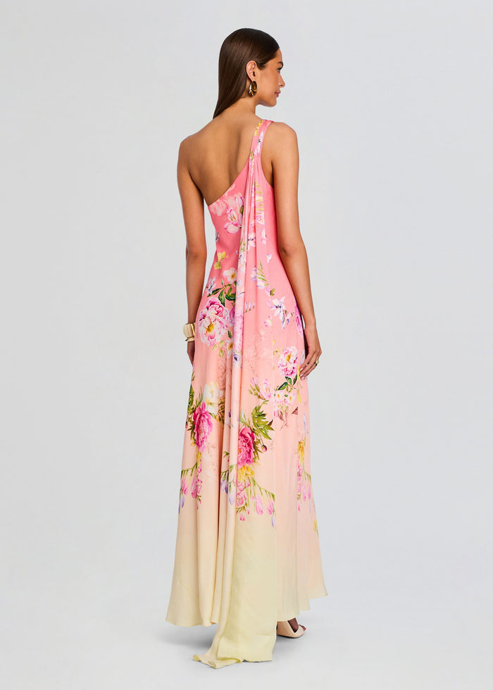 Back view of a pink floral Avya one shoulder sash dress with a long draped sash media 4 of 5