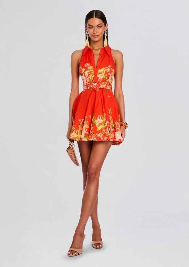 Model wearing Hibi Short Dress With Belt Buckle in red with floral print and a matching circular belt buckle.