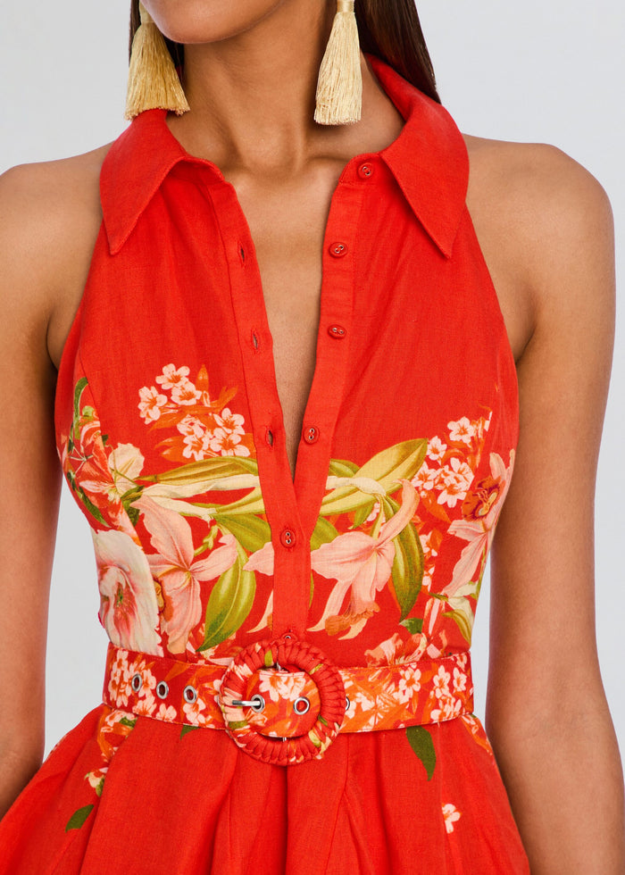Close-up of Hibi Short Dress With Belt Buckle bodice showing red fabric, floral print and circular belt buckle. media 2 of 5