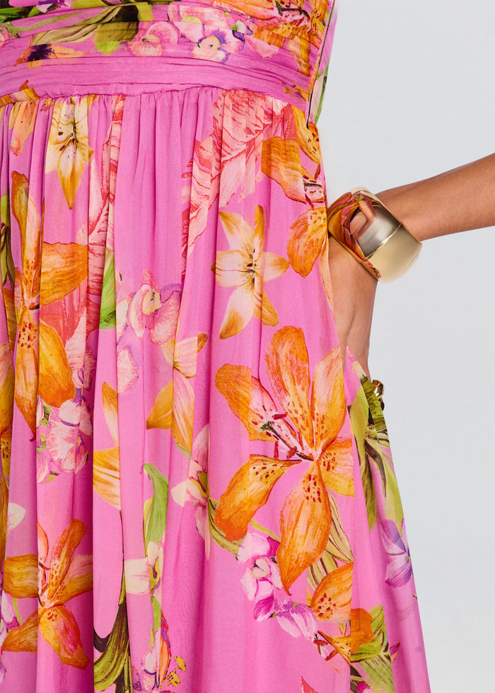 Close-up of the pink floral Posy dress showing a smocked strapless bodice and vibrant orange and yellow flowers media 2 of 5
