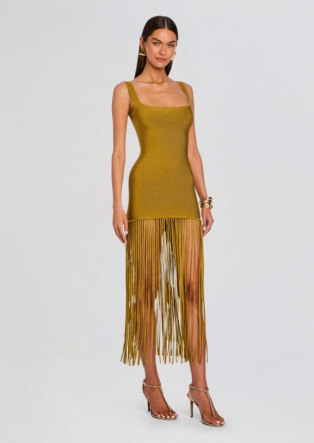 Mustard Saddler Dress with thick straps and square neckline, bodycon knit and long fringe hem on a model.