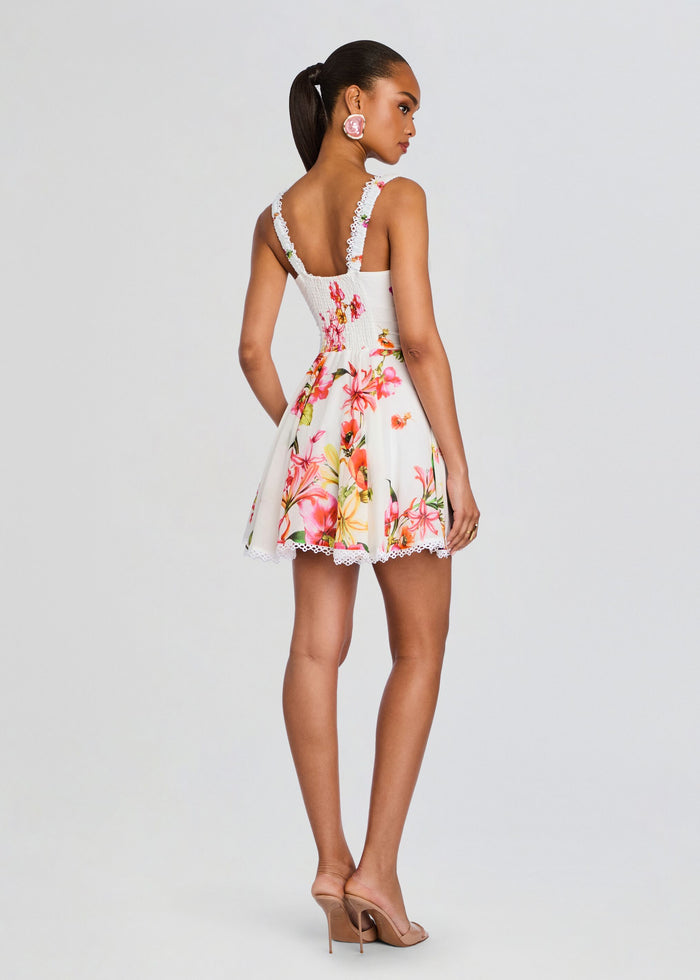 Back view of a model in Bora Short Dress a white floral mini with lace-trim straps and a scalloped hem media 4 of 5