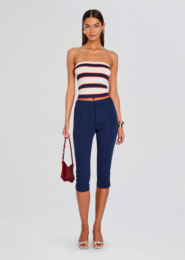 Theodora Tube Top striped in cream navy red worn with navy pants and a small burgundy handbag.