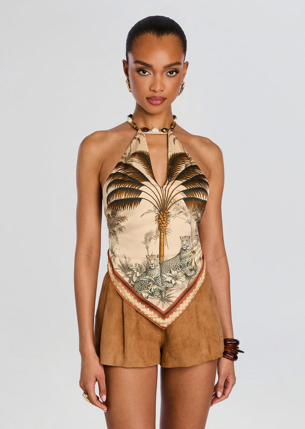 Zaphira Top halter neck with palm tree print worn with tan suede shorts and shell jewelry