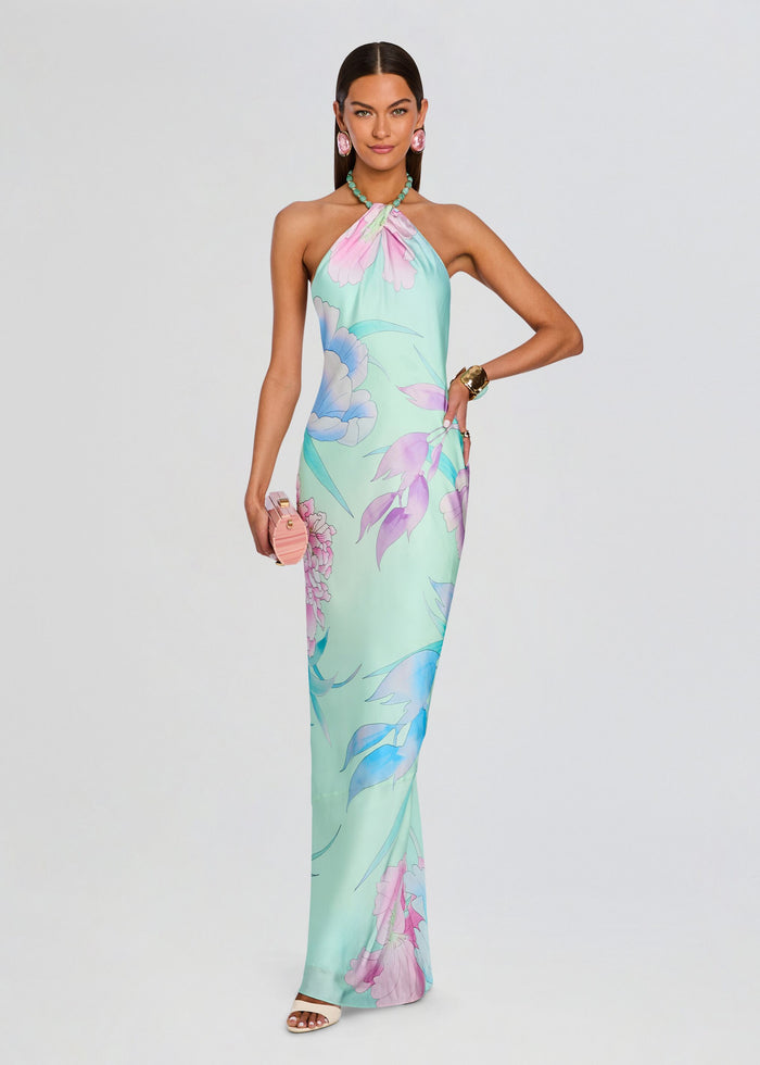 Model in a pastel floral Anat Dress halter neck maxi dress in mint with pink and purple blossoms media 1 of 5
