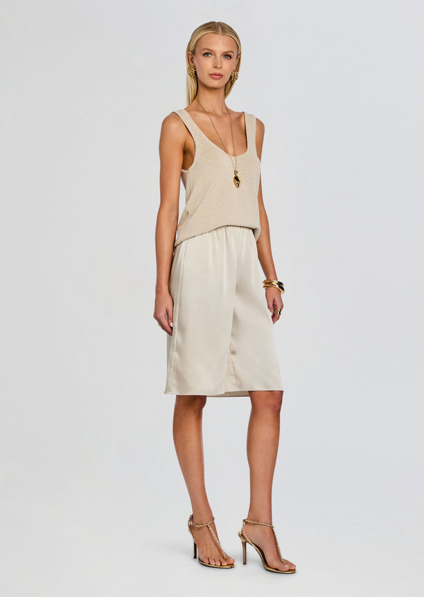 Full model wearing beige Brice Bermuda Short with a matching tank top and gold strappy sandals.