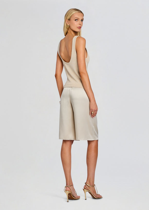 Back view of Brice Bermuda Short outfit with beige knit tank top and cream satin shorts and brown belt