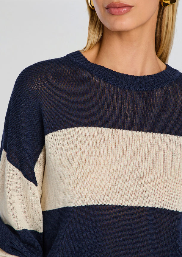 Close-up of the Cassian Sweater showing navy body beige stripe and ribbed crew neck