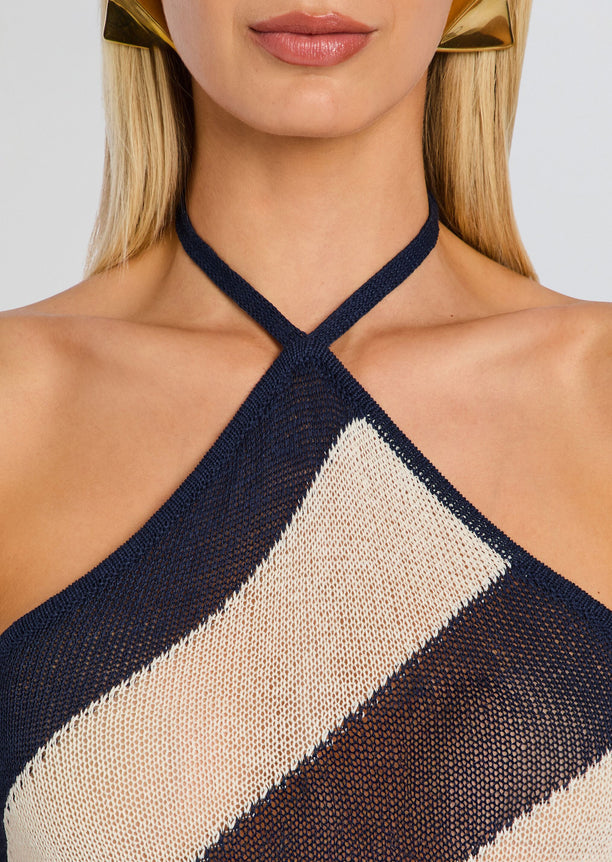 Close up of the halter cross strap neckline on the Dree Knit Maxi Dress showcasing navy and beige diagonal knit pattern