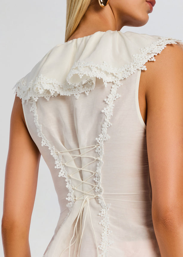 Back view of white Myrth Top with lace trim and corset style lacing.