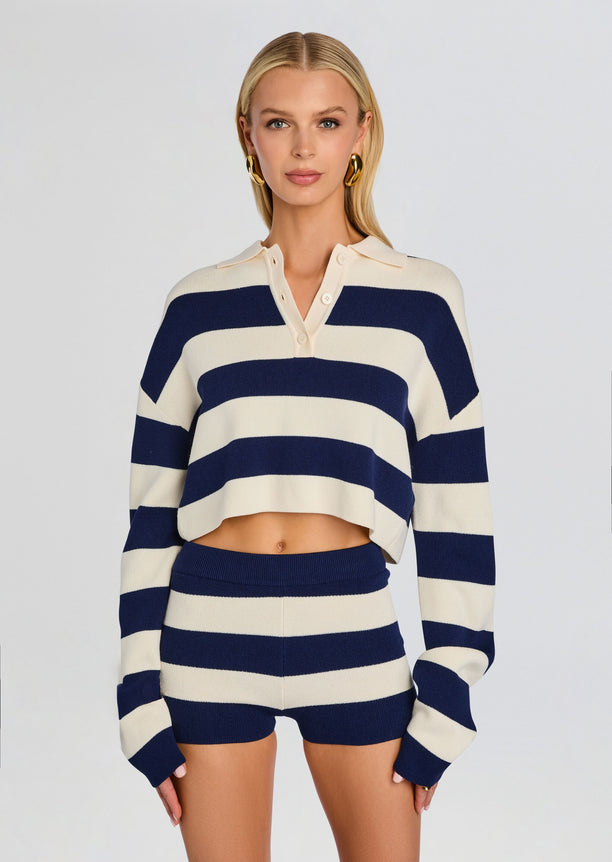 Model wearing a cropped navy and cream striped Ryla Sweater with matching striped shorts.