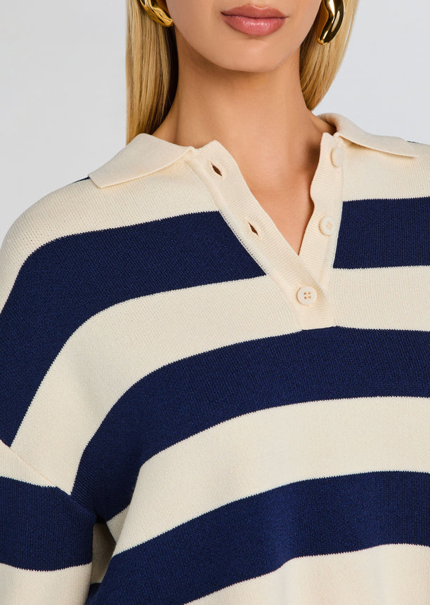 Cream and navy striped knit sweater with a polo collar and button placket.