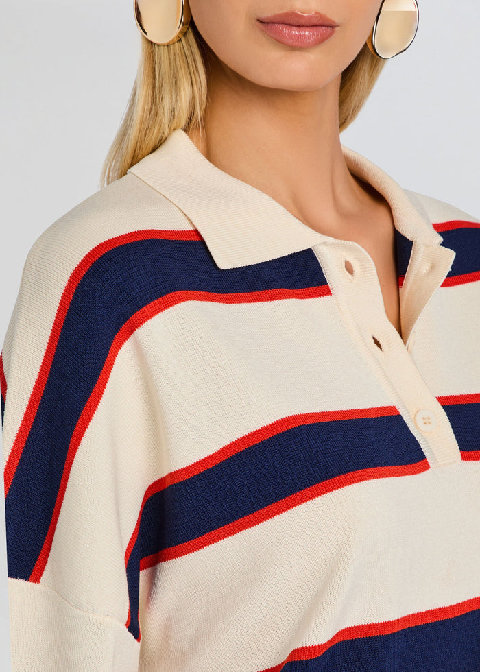 Close up of Taby Sweater showing cream knit with navy and red stripes and a polo collar. media 3 of 5