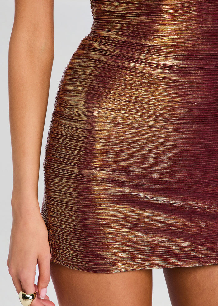 Close-up of a bodycon mini dress with a metallic bronze and gold pleated texture, worn by a model. media 2 of 5