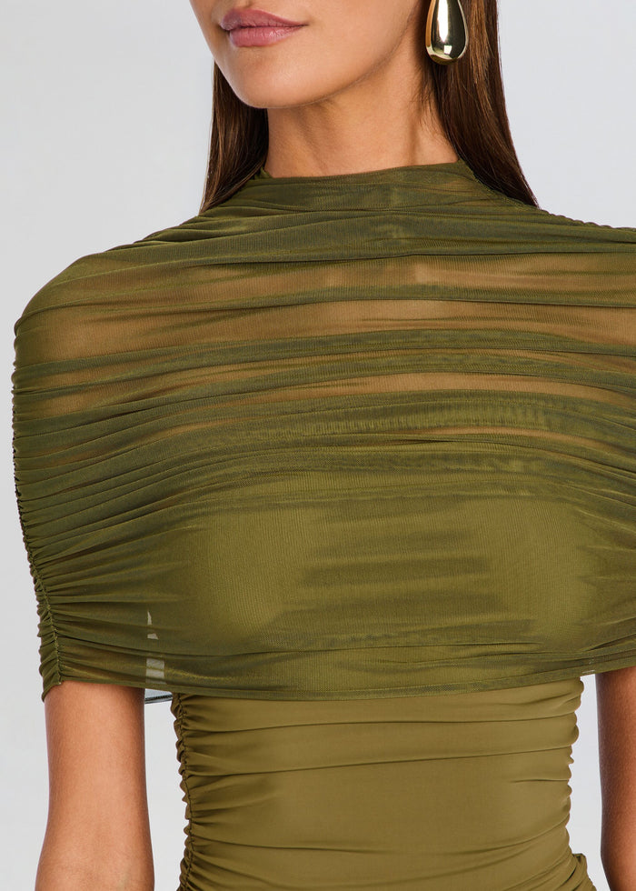 Close-up of a model wearing an olive green ruched sheer mesh top with a high mock neck and short sleeves. media 2 of 5