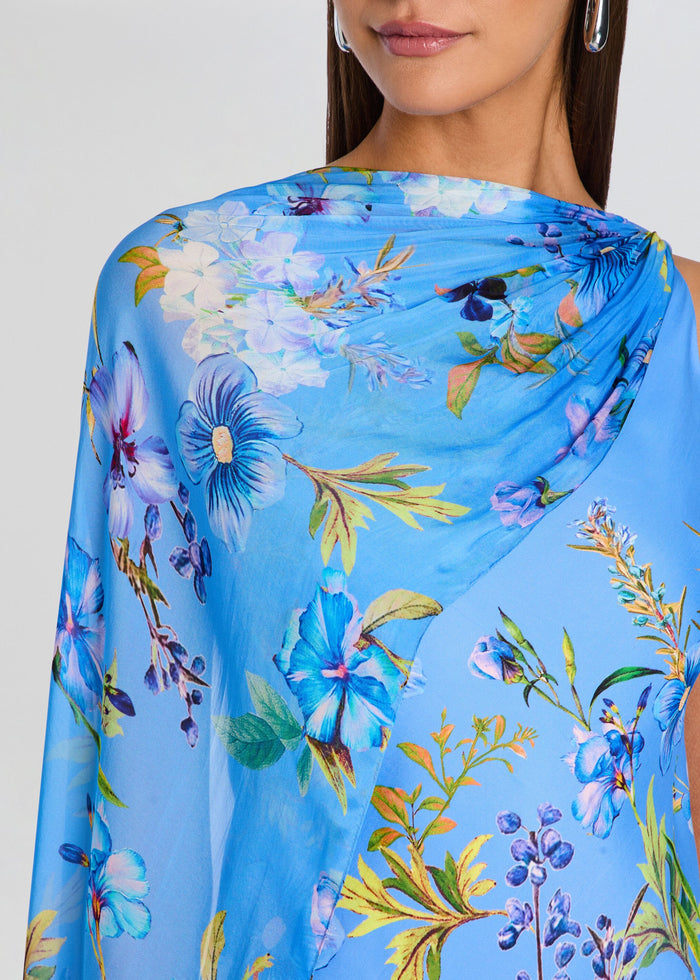 Woman wearing a blue floral scarf with a plain background media 2 of 5