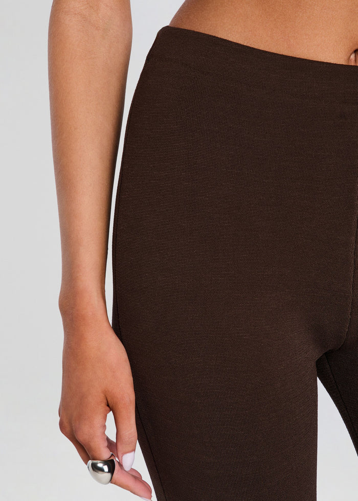 Brown leggings worn by a person on a plain background media 3 of 5