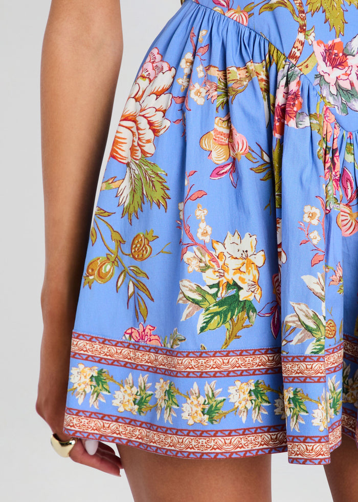 Blue floral skirt with colorful patterns on a plain background media 2 of 5