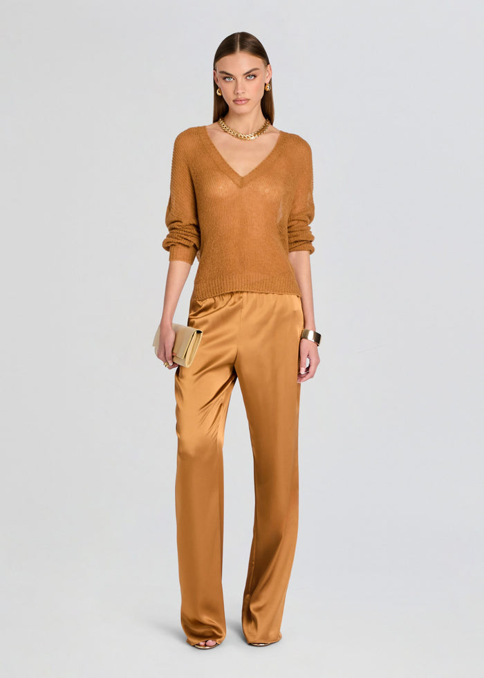 Woman wearing a brown outfit with a plain background media 2 of 5